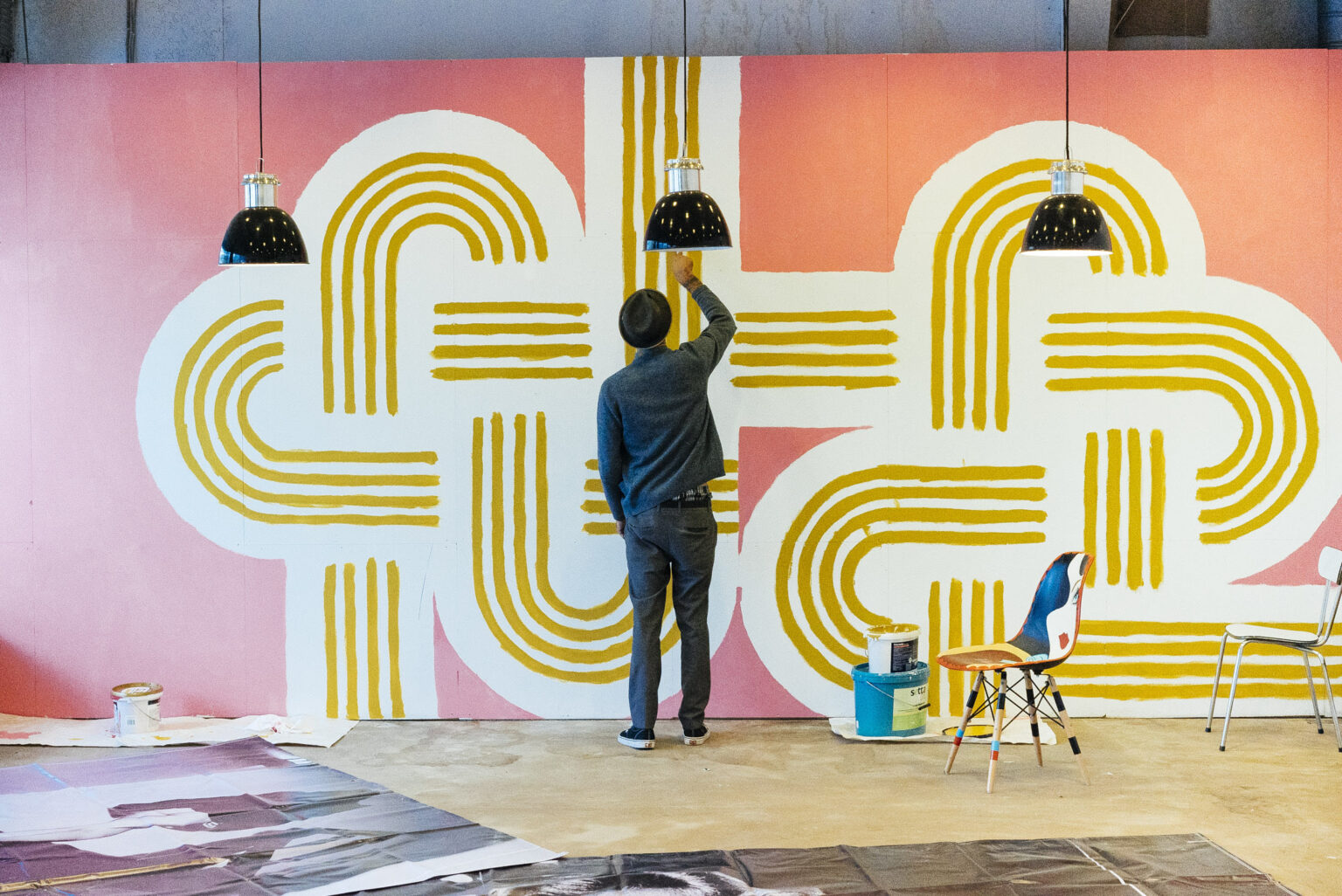 AARON ROSE: SURRENDER Aaron Rose painting a wall piece for one of his exhibitions