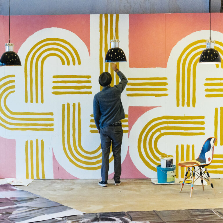 AARON ROSE: SURRENDER Aaron Rose painting a wall piece for one of his exhibitions